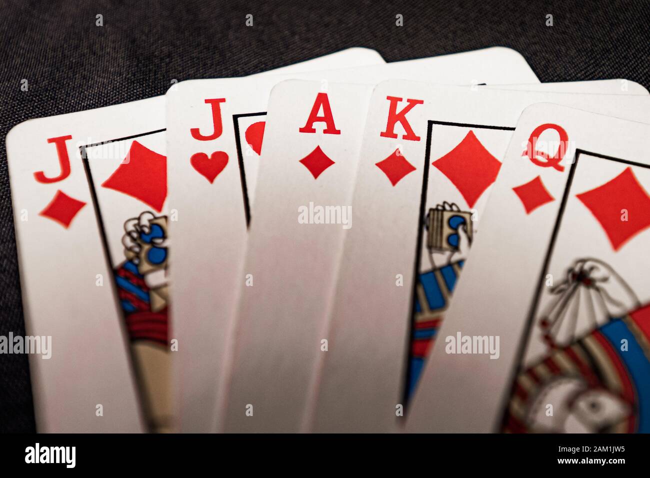 red euchre diamond hand on black background Stock Photo