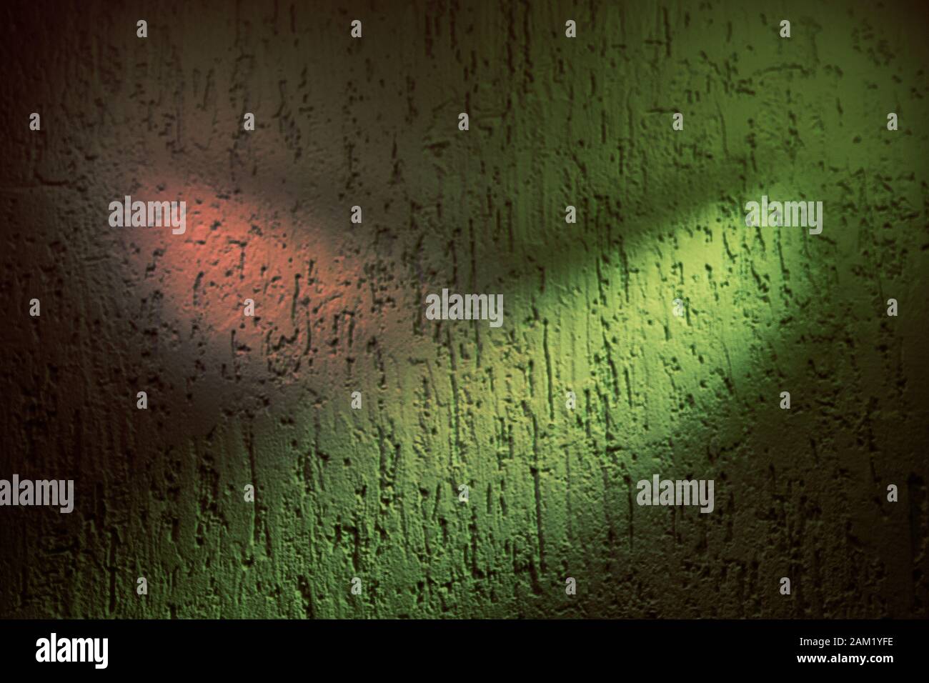 Pink spot and yellow ray of light on a textural background Stock Photo