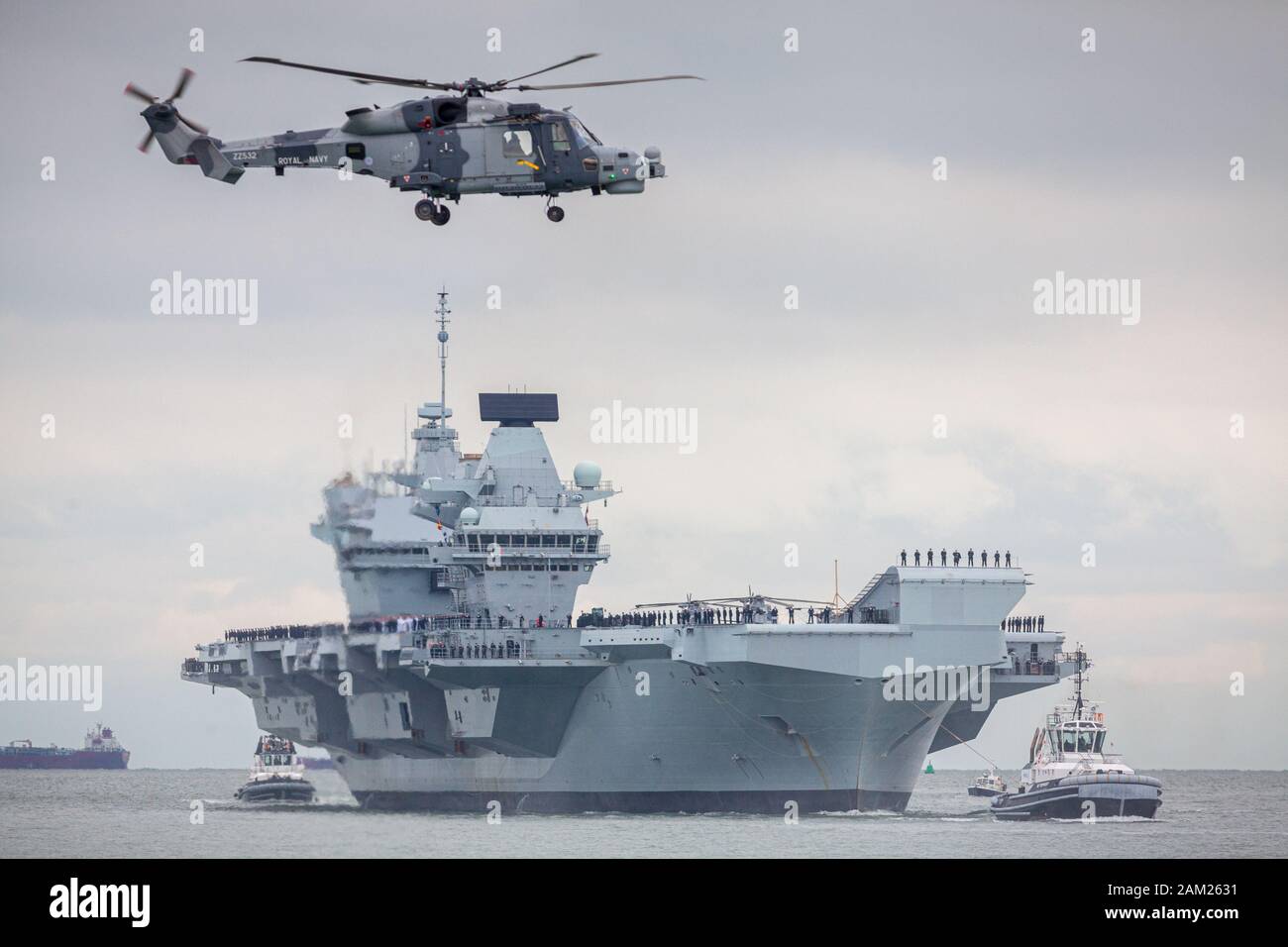 HMS Prince of Wales, the Royal Navy's second Queen Elizabeth-class aircraft carrier, sails into Portsmouth Naval Base for the first time this afternoo Stock Photo