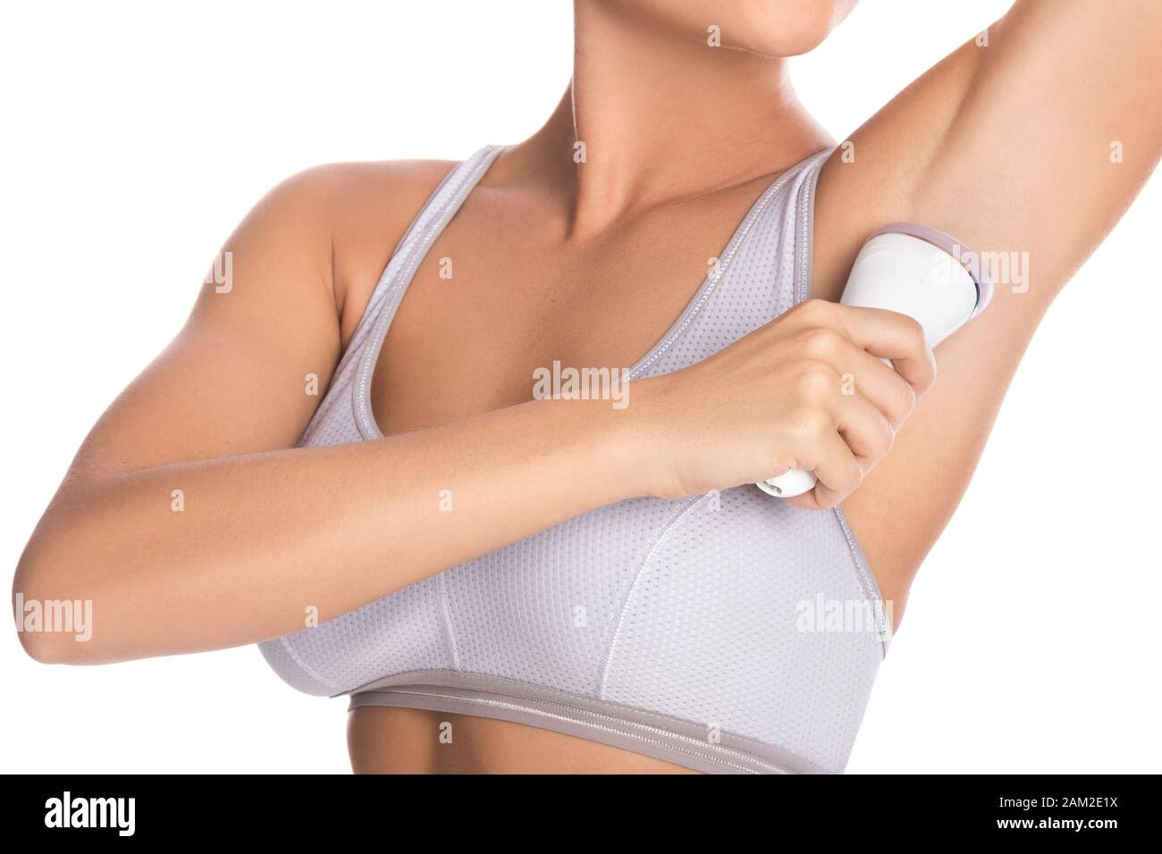 Woman using epilator on her armpit over white background Stock Photo - Alamy