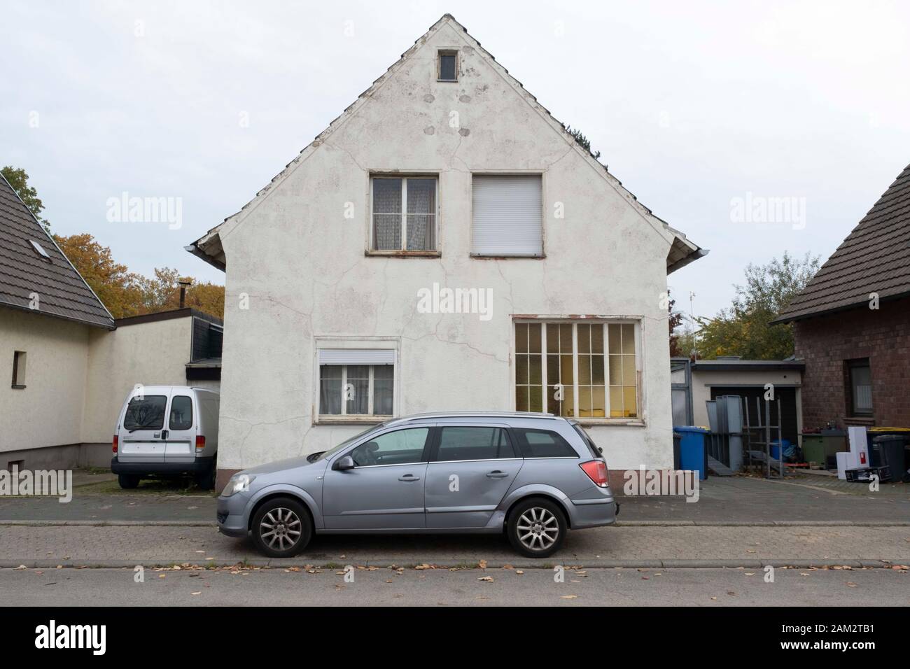 Cars parked outside house in town abandoned for coal mining, Mannheim, Germany Stock Photo
