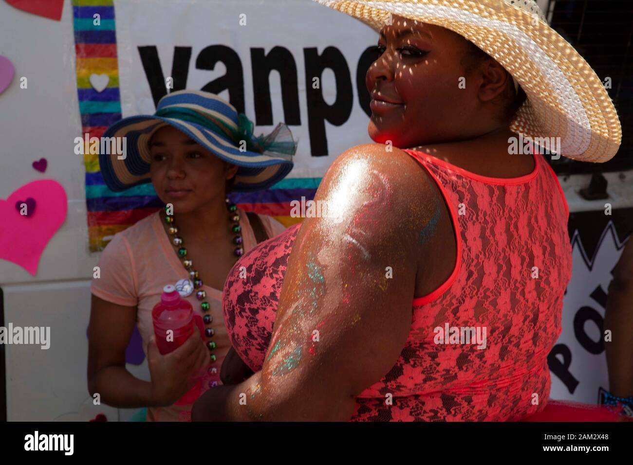 Friends at Pride parade posing in sun hats and lace tank top, Vancouver Pride Festival 2014, Vancouver, Canada Stock Photo