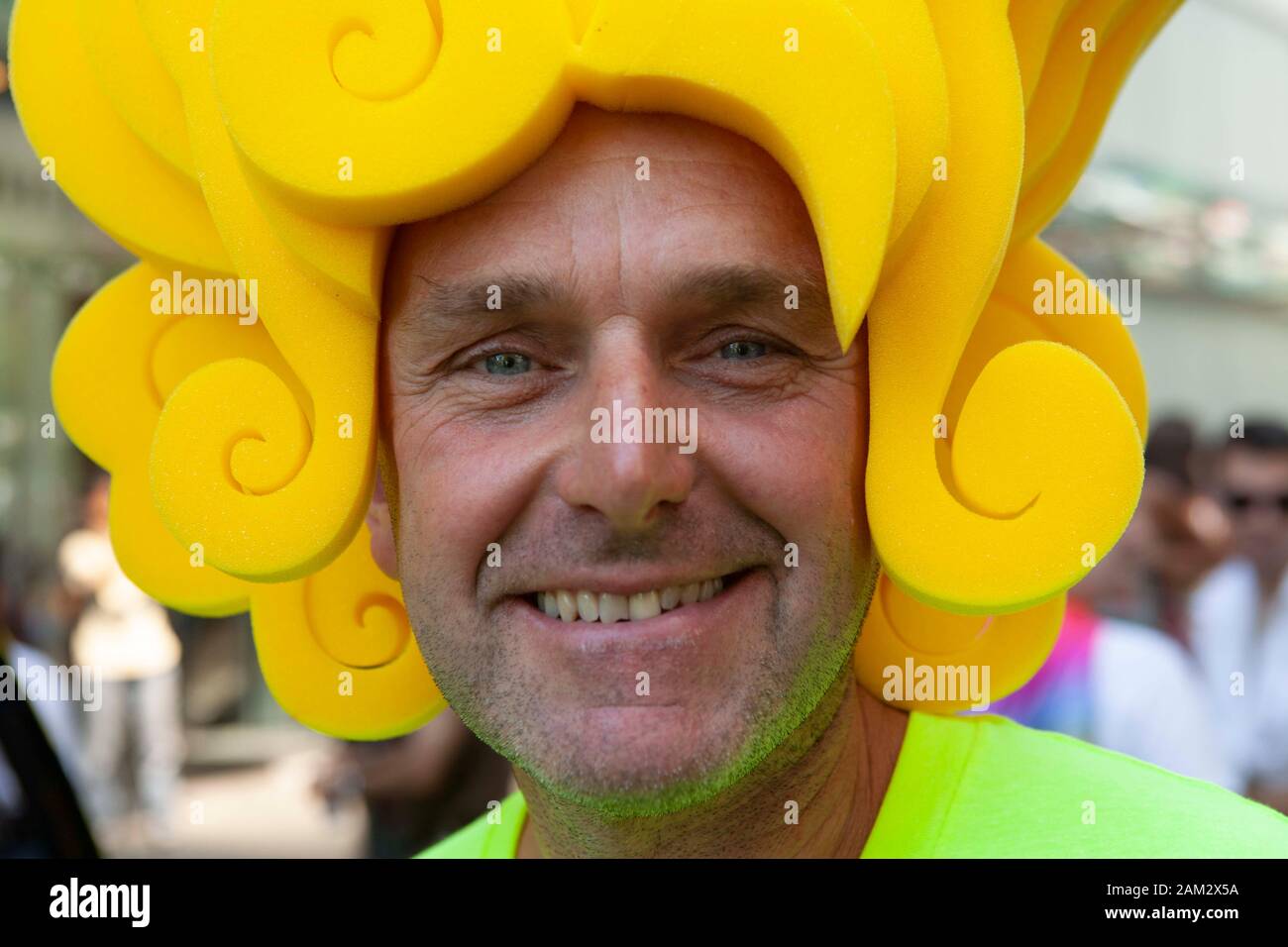 Pride parade participant in yellow wig made out of sponge, Vancouver Pride Festival 2014, Vancouver, Canada Stock Photo