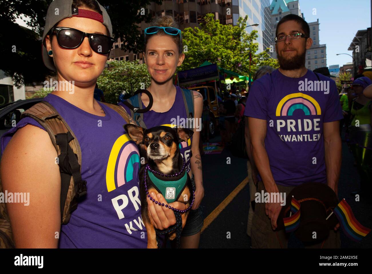 Pride parade participants in Pride Kwantley t-shirts with pet dog, Vancouver Pride Festival 2014, Vancouver, Canada Stock Photo