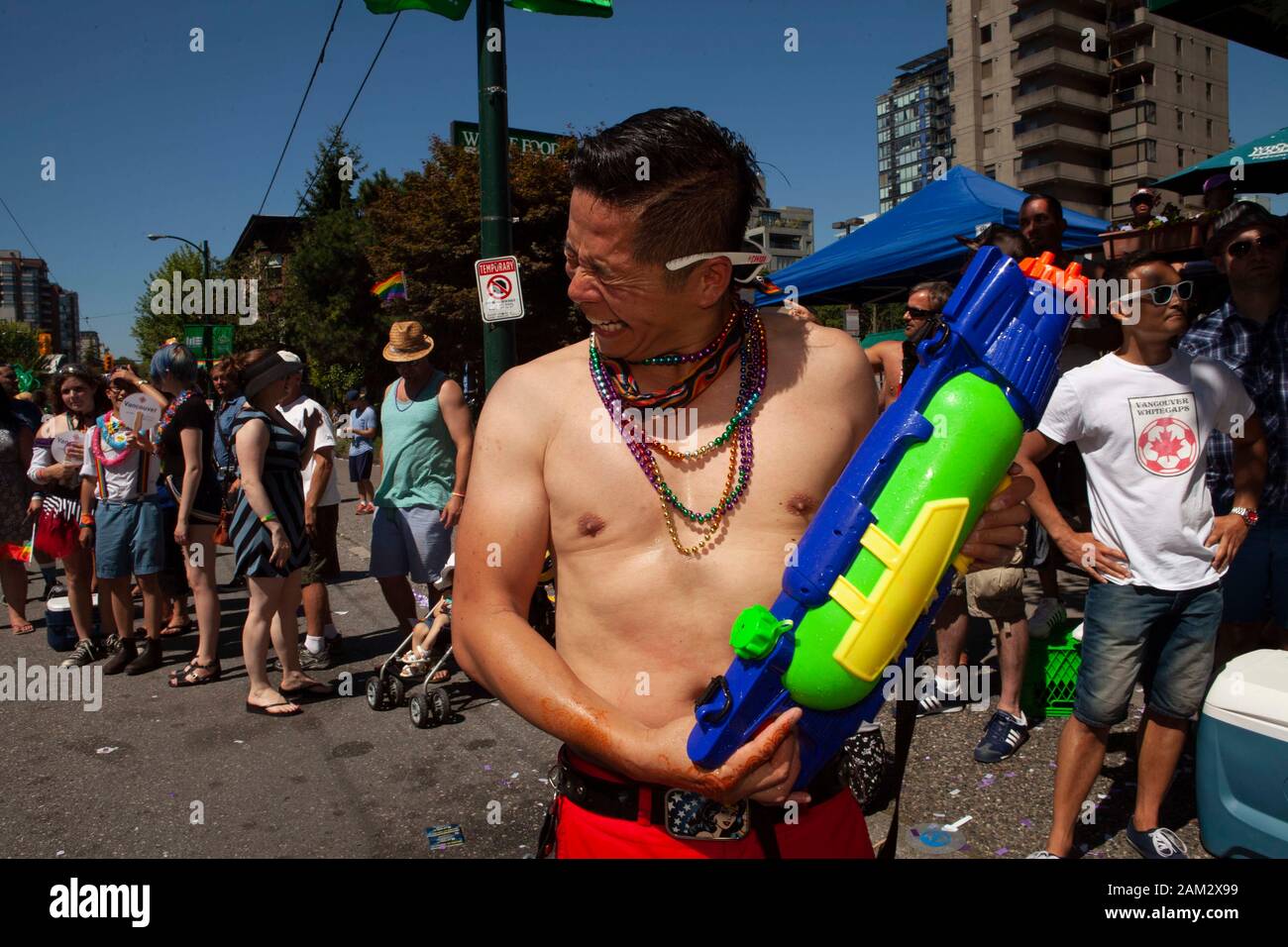 Pride parade participant cooling down with water gun, Vancouver Pride Festival 2014, Vancouver, Canada Stock Photo