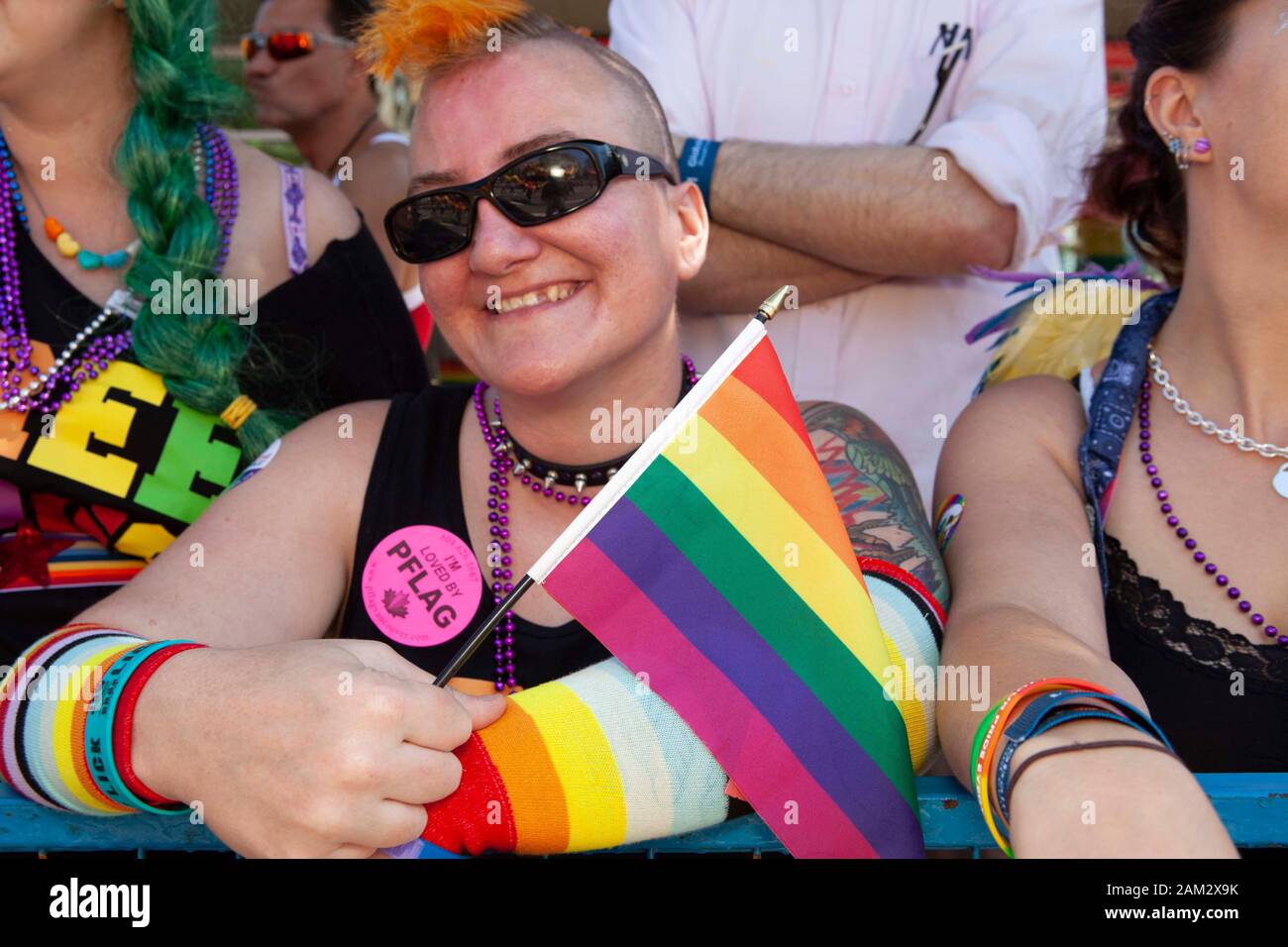 Cheerful Pride parade participant with rainbow flag, Vancouver Pride Festival 2014, Vancouver, Canada Stock Photo
