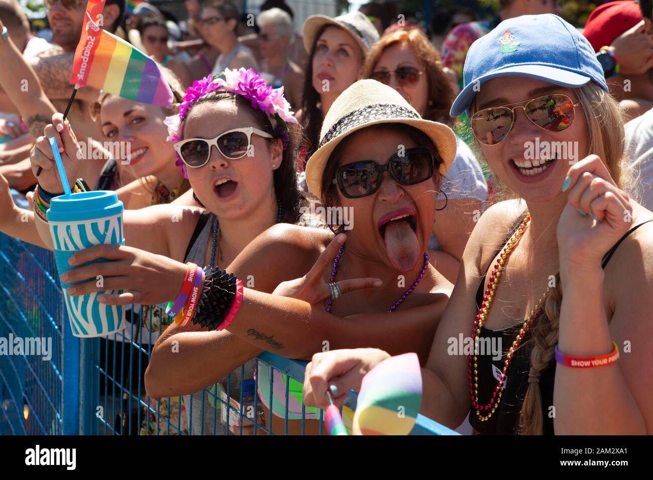 Pride parade participants making faces and gestures at barriers of parade, Vancouver Pride Festival 2014, Vancouver, Canada Stock Photo