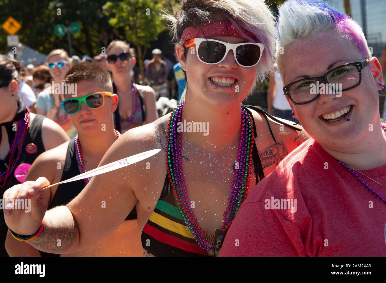 Happy Pride parade participants wearing accessories of rainbow colours, Vancouver Pride Festival 2014, Vancouver, Canada Stock Photo