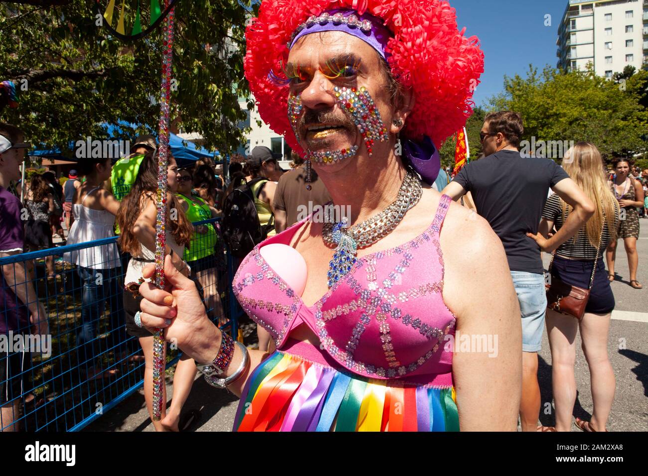 Pride parade participant with bejewelled face and bright red wig, Vancouver Pride Festival 2014, Vancouver, Canada Stock Photo