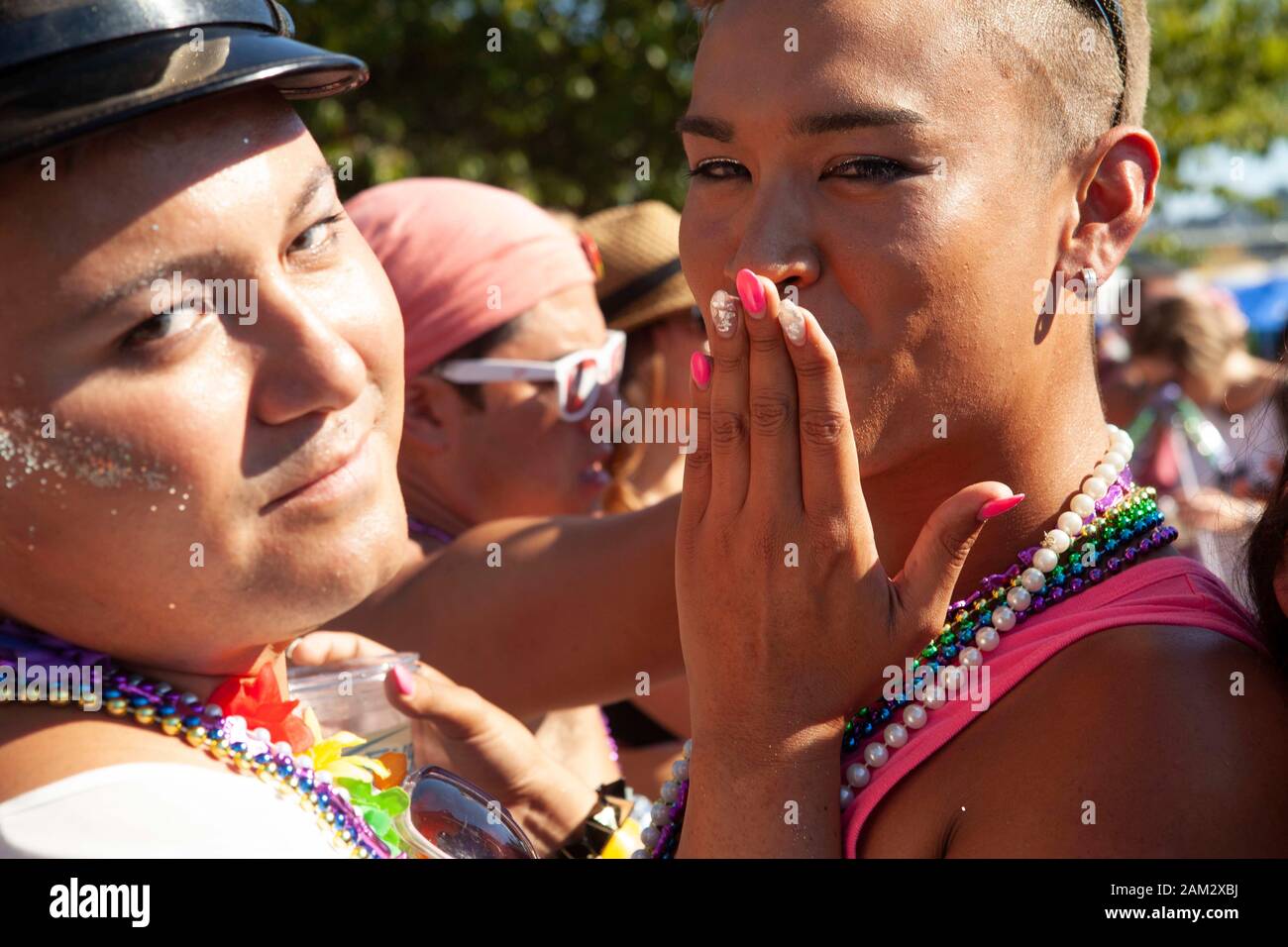 Close up portrait of friends hugging at festival, Vancouver Pride Festival 2014, Vancouver, Canada Stock Photo