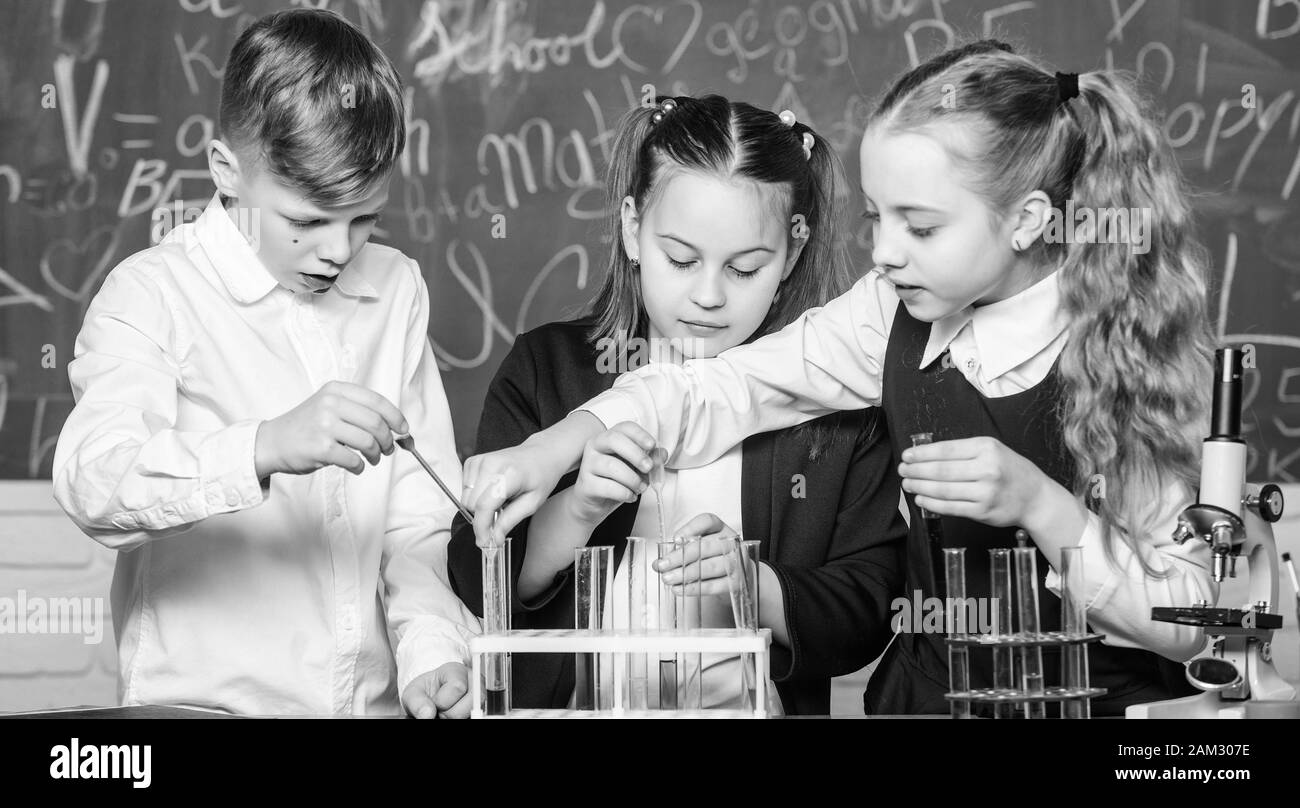 Little children. Science. biology experiments with microscope. Lab microscope and testing tubes. Chemistry science. Little kids scientist earning chemistry in school lab. Ready for final exam. Stock Photo