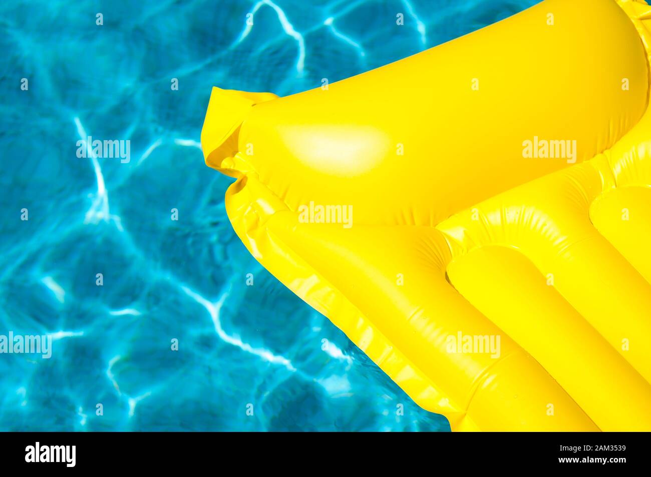 Empty inflatable raft in bright floating on blue swimming pool in ...