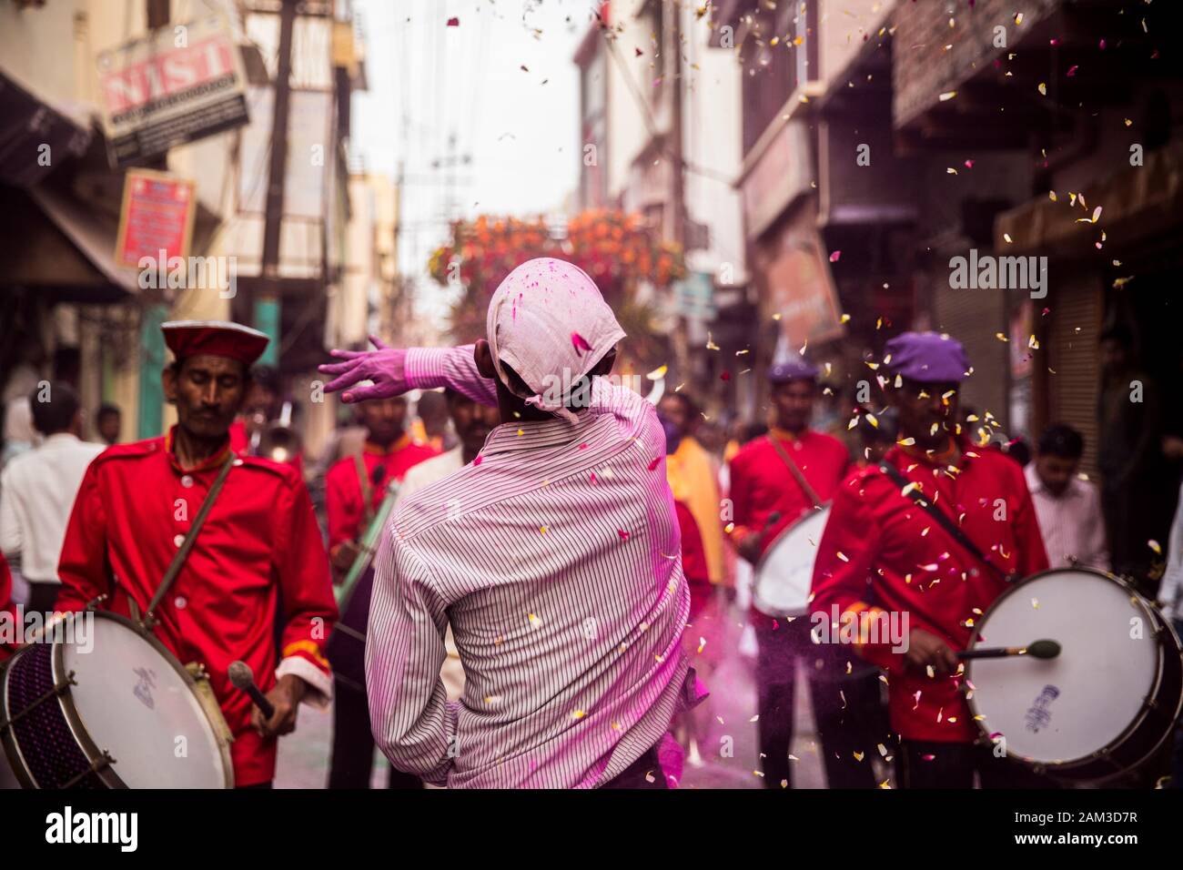 Man throwing flowers during Holi festival in Mathura. India Stock Photo