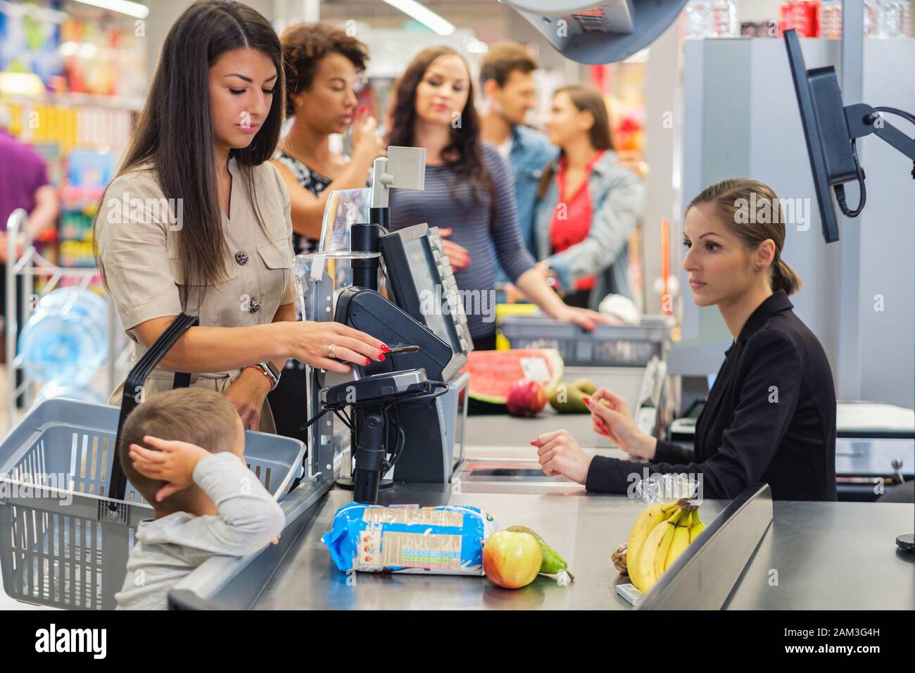 Woamn with a son in a grocery store Stock Photo