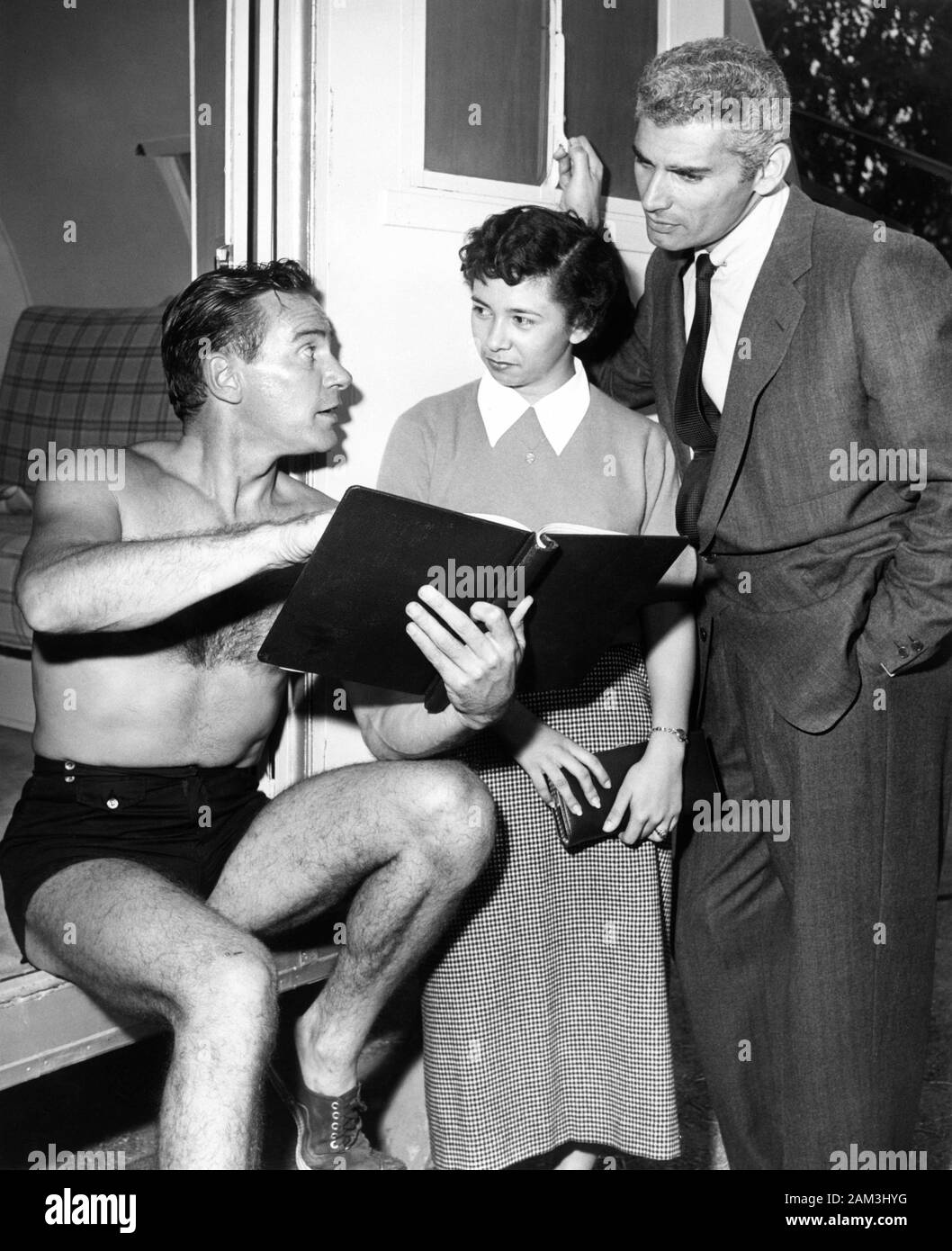 RICHARD CARLSON in his trailer dressing room on the Universal Backlot visited by JEFF CHANDLER and one of his fans during filming of  CREATURE FROM THE BLACK LAGOON 1954 director JACK ARNOLD filmed in 3D producer William Alland Universal International Pictures (UI) Stock Photo