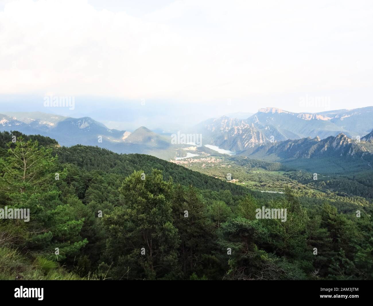 Panoramic view of the pre-Pyrenean area of Catalonia, with the Sierra Cadi, Llosa del Cavall pond and the small town of San Lorenzo de Morunys. Catalo Stock Photo
