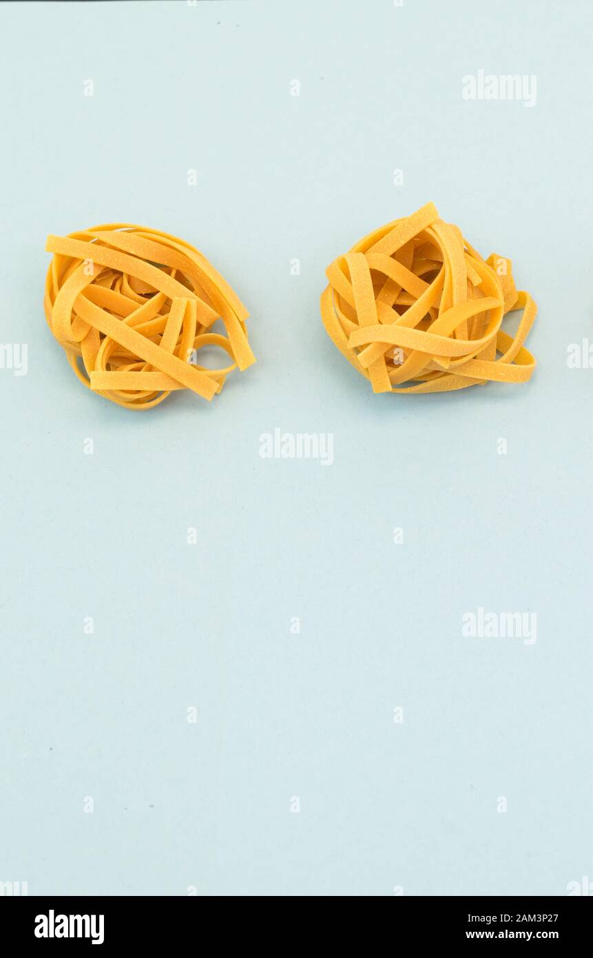 italian tagliatelle nest on a light blue background - natural food ...