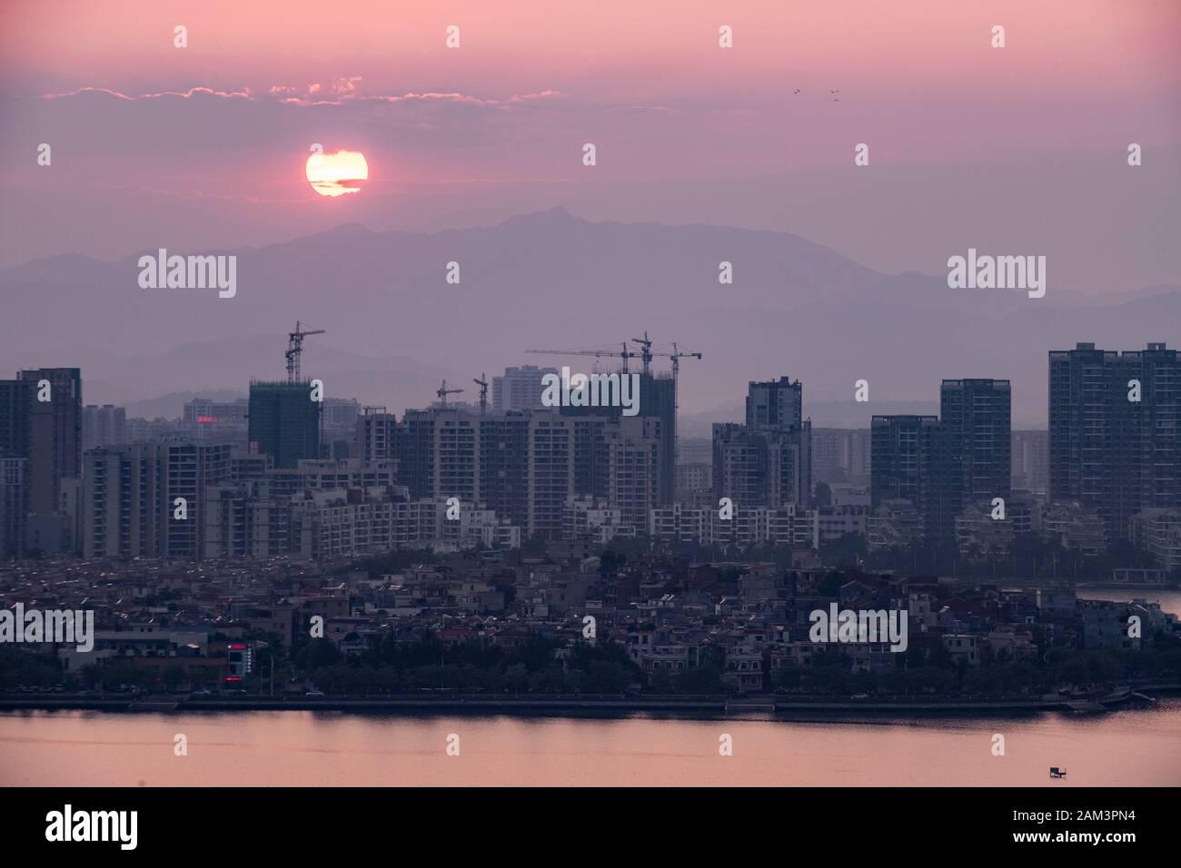 The City of Zhaoqing at sunset,taken from the top of a karst mountain in the Seven Star Crags national park (Qixing Yan) People's Republic of China Stock Photo