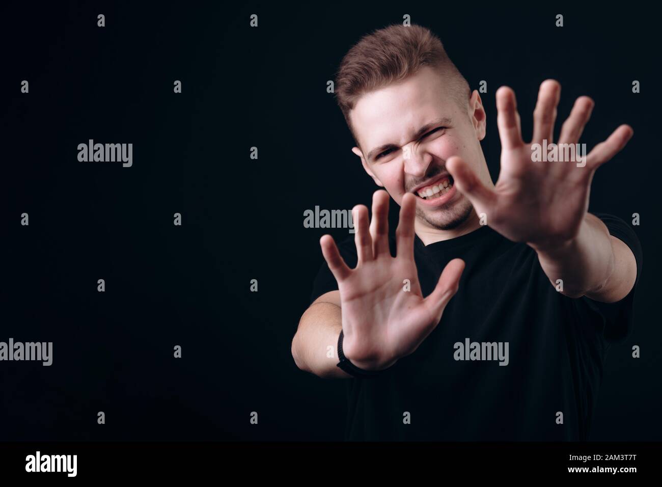 Young Man Showing Rejection Emotions Stretching His Palms Stock Photo