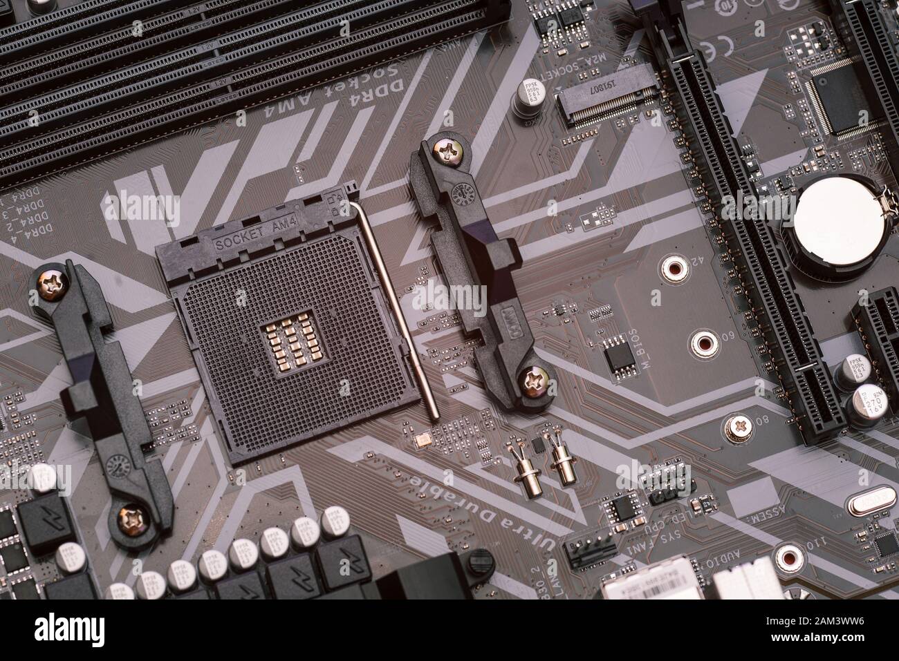Computer motherboard without processor. Assembling parts for a server or home computer. Empty space for the processor and RAM. Stock Photo