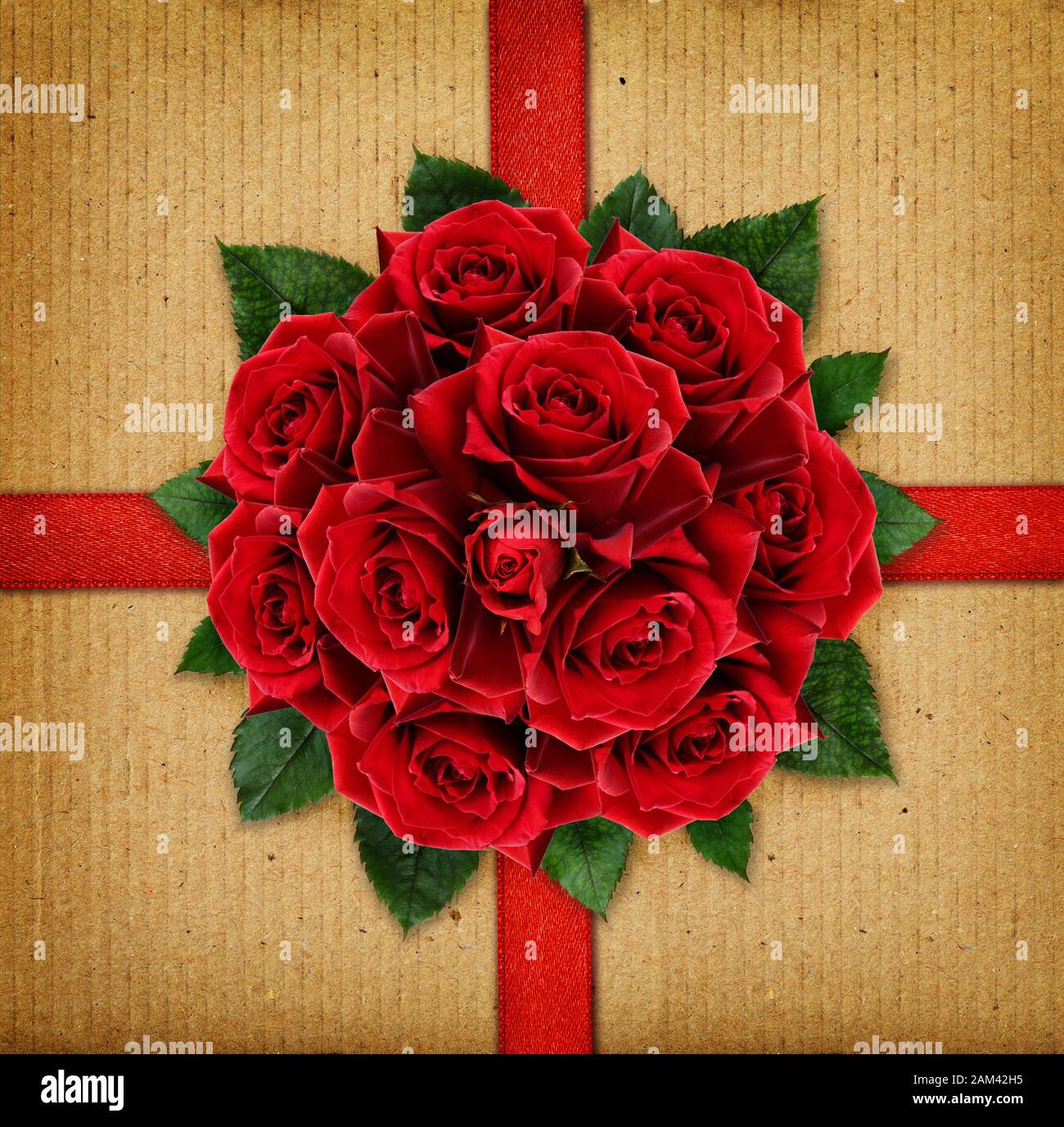 Red rose flowers bouquet and a ribbon on cardboard background Stock
