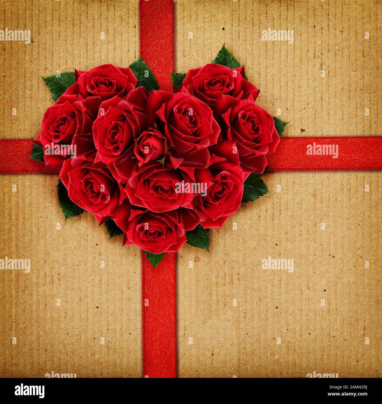 Red rose flowers heart and a ribbon on cardboard background Stock Photo ...