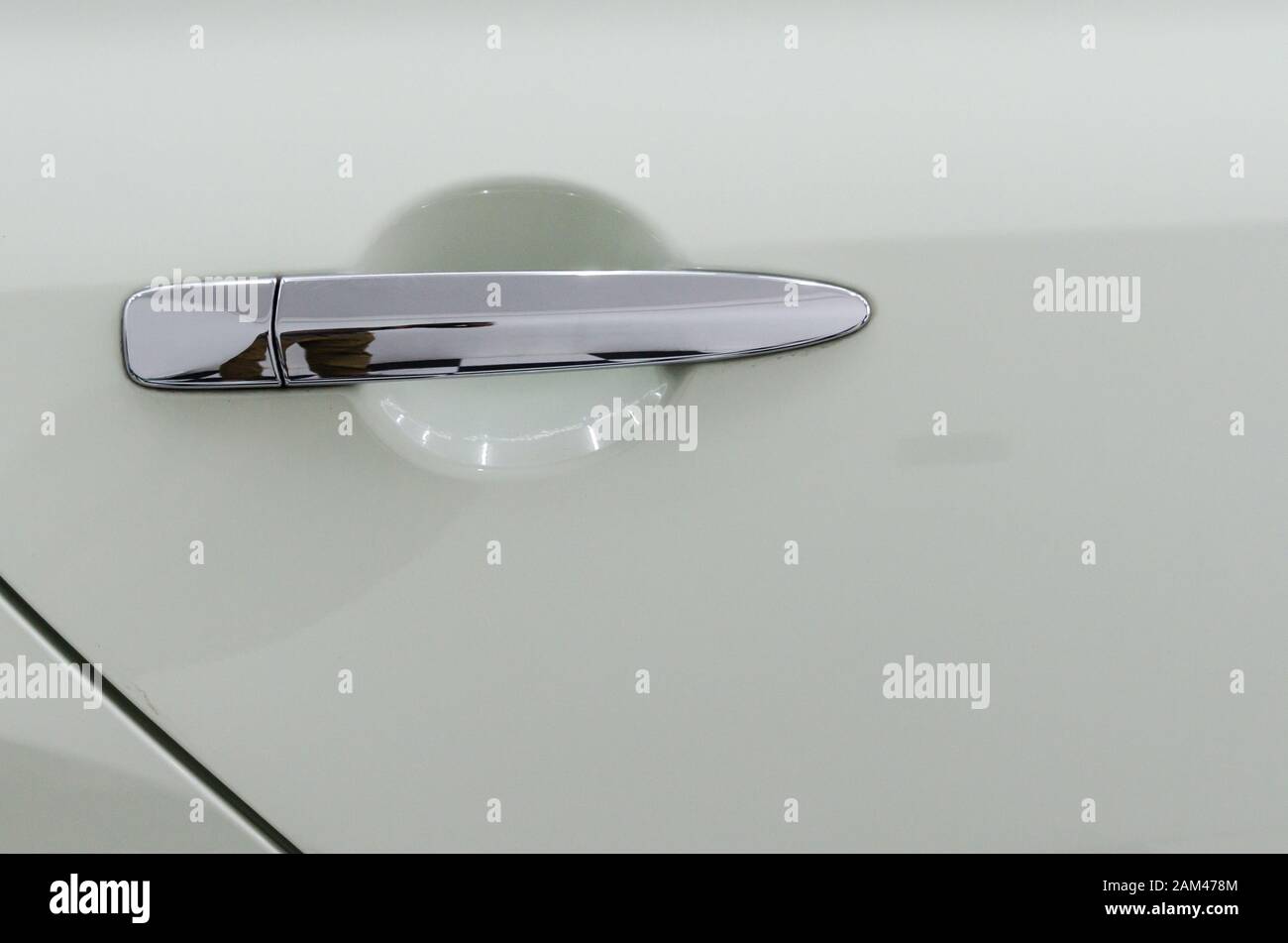 Modern white car door handle.Car door handle is an external part of the