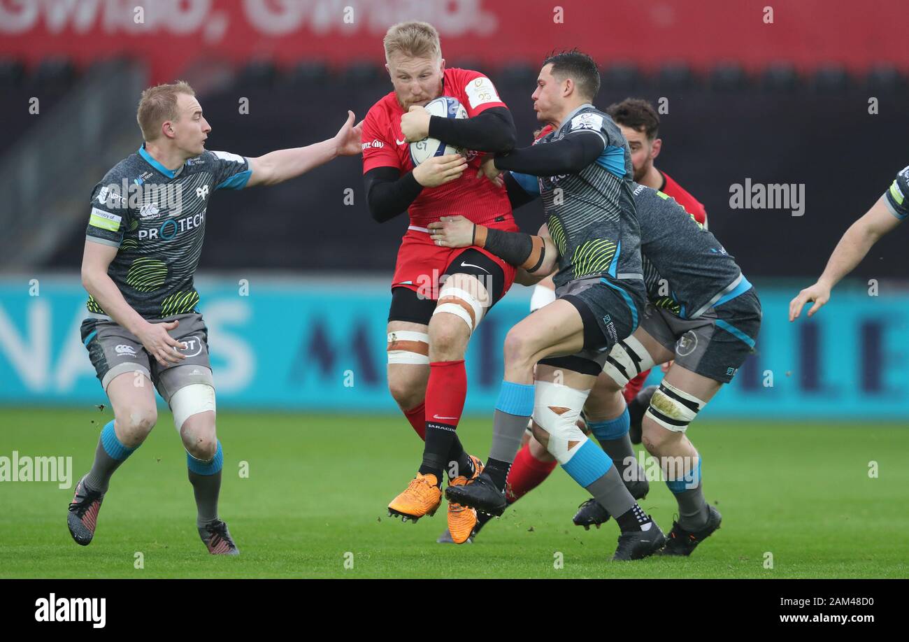 Saracens Jackson Wray is tackled by Ospreys Luke Price and Shaun Venter during the Heineken Champions Cup pool four match at the Liberty Stadium, Swansea Stock Photo