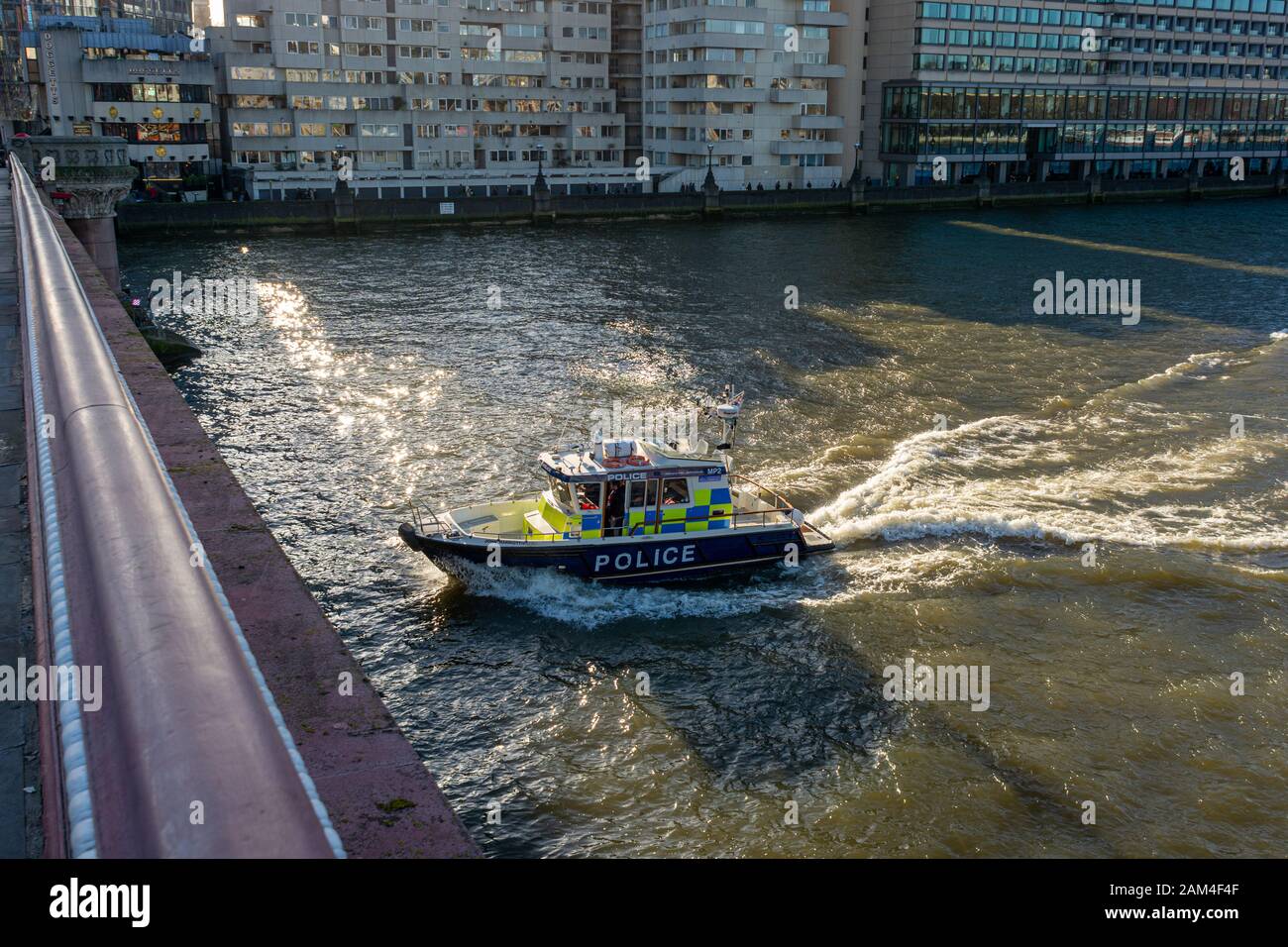 River police boat passing under Blackfriars bridge, River Thames, London Stock Photo
