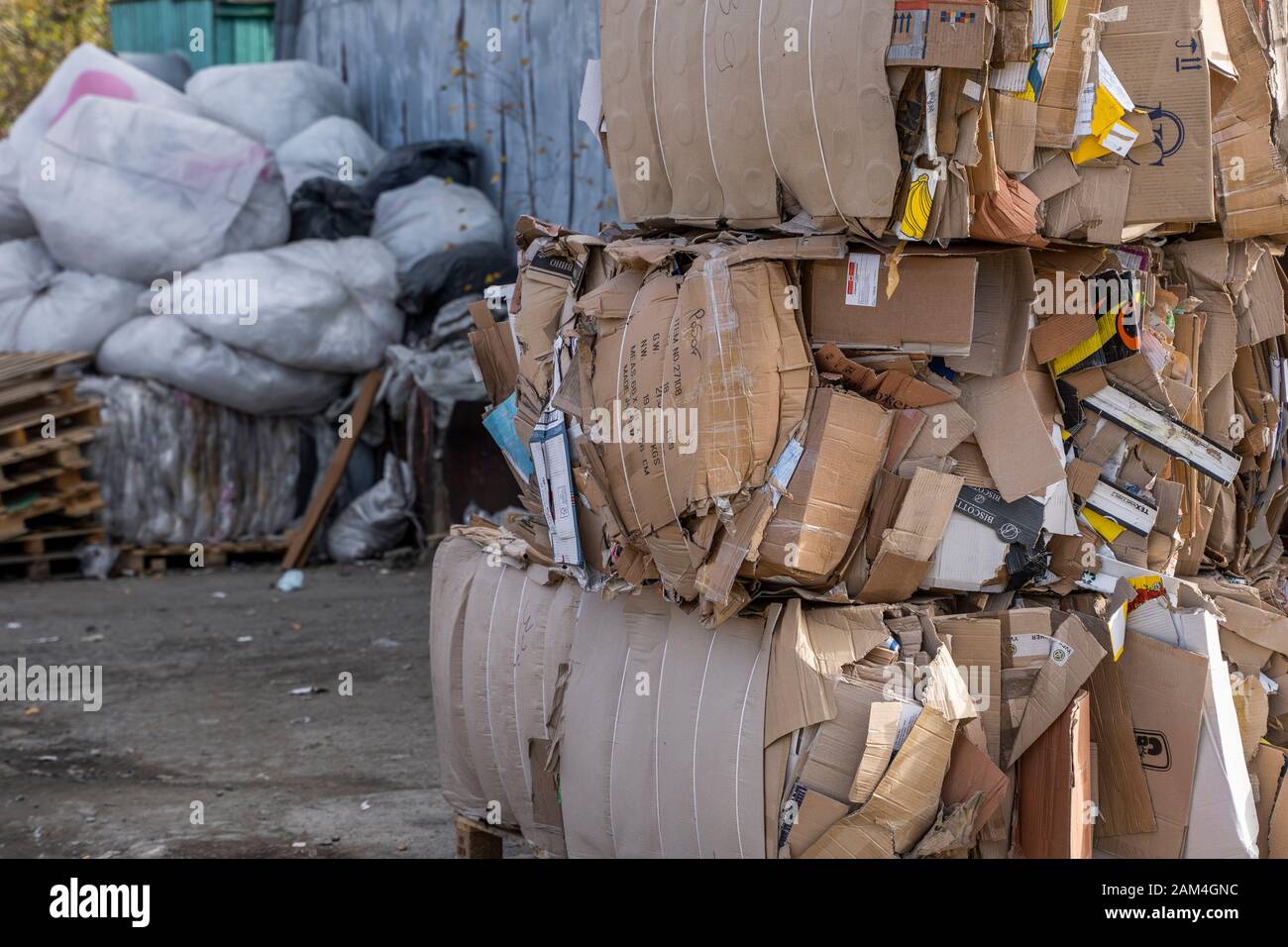 Bales of cardboard and box board with strapping wire ties. Background of  paper textures piled ready to recycle Stock Photo - Alamy