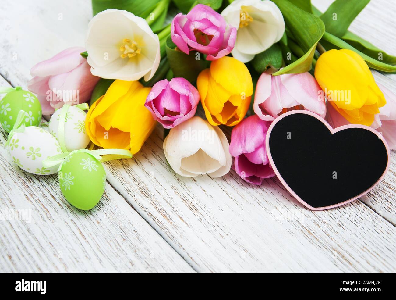 Easter eggs and tulips on a old wooden table Stock Photo - Alamy