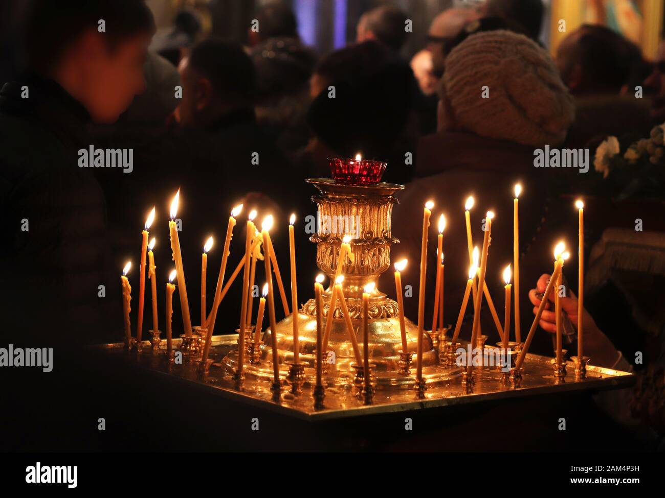 nocturnal christmas service in a russian orthodox church, close-up of burning candles Stock Photo