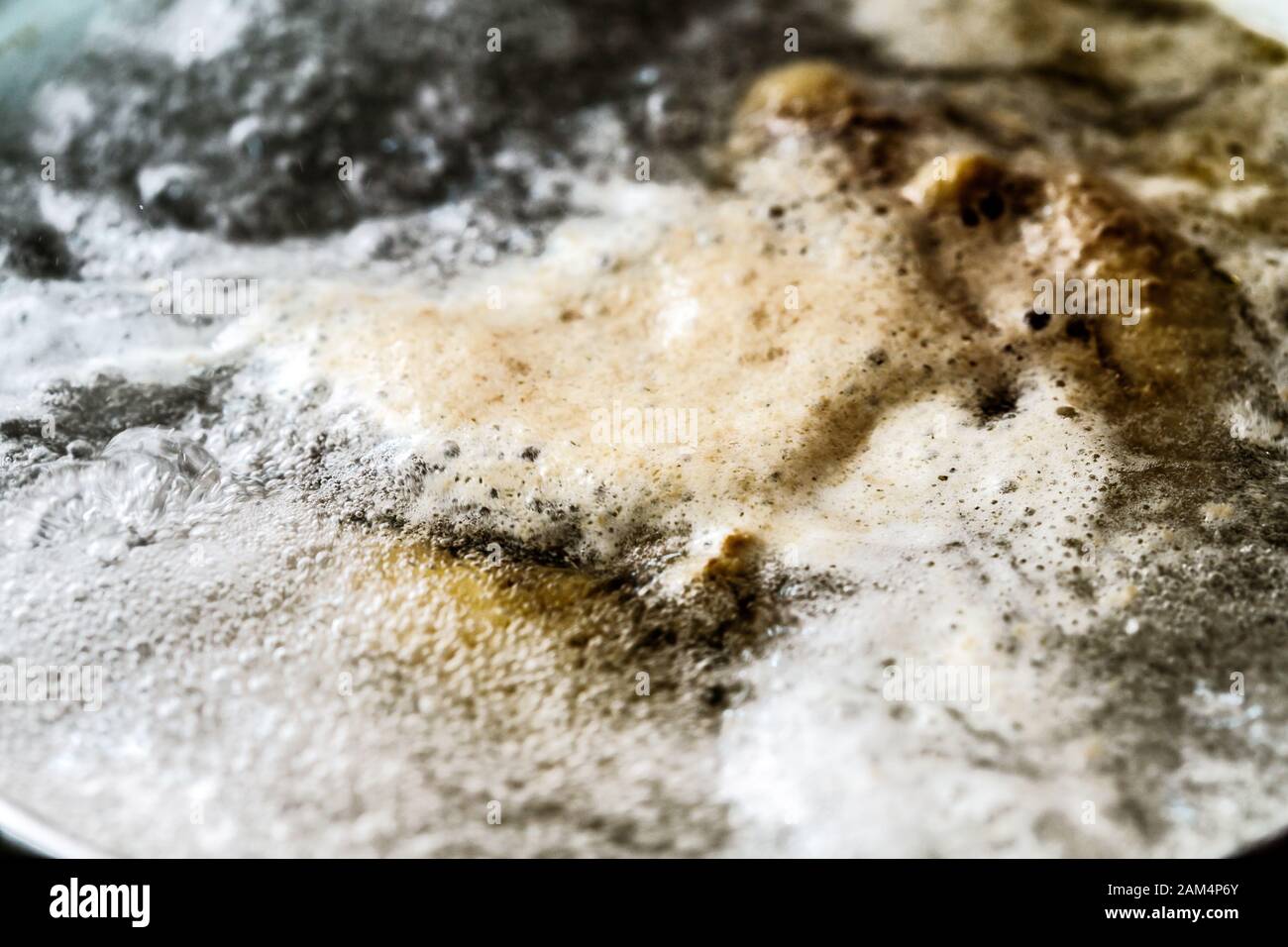 Boiling foam in a saucepan on an electric stove Stock Photo