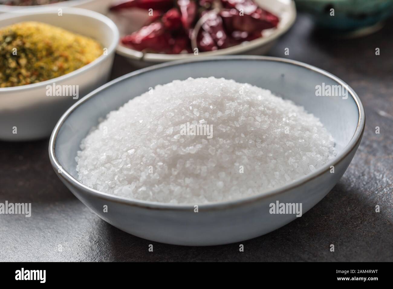 Salt and variety spices and herbs in bowls Stock Photo