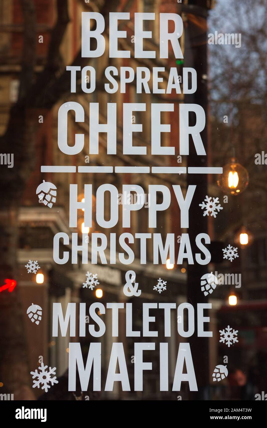 beer to spread cheer sign on a window in a pub Stock Photo