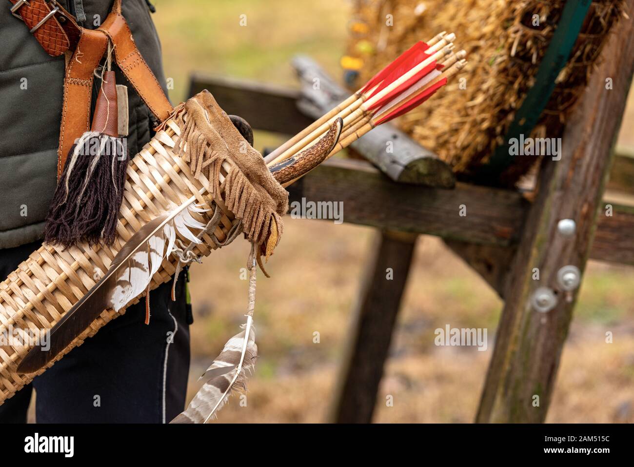 Closeup of an archer with a vintage quiver and wooden arrows Archery sport, longbow Stock