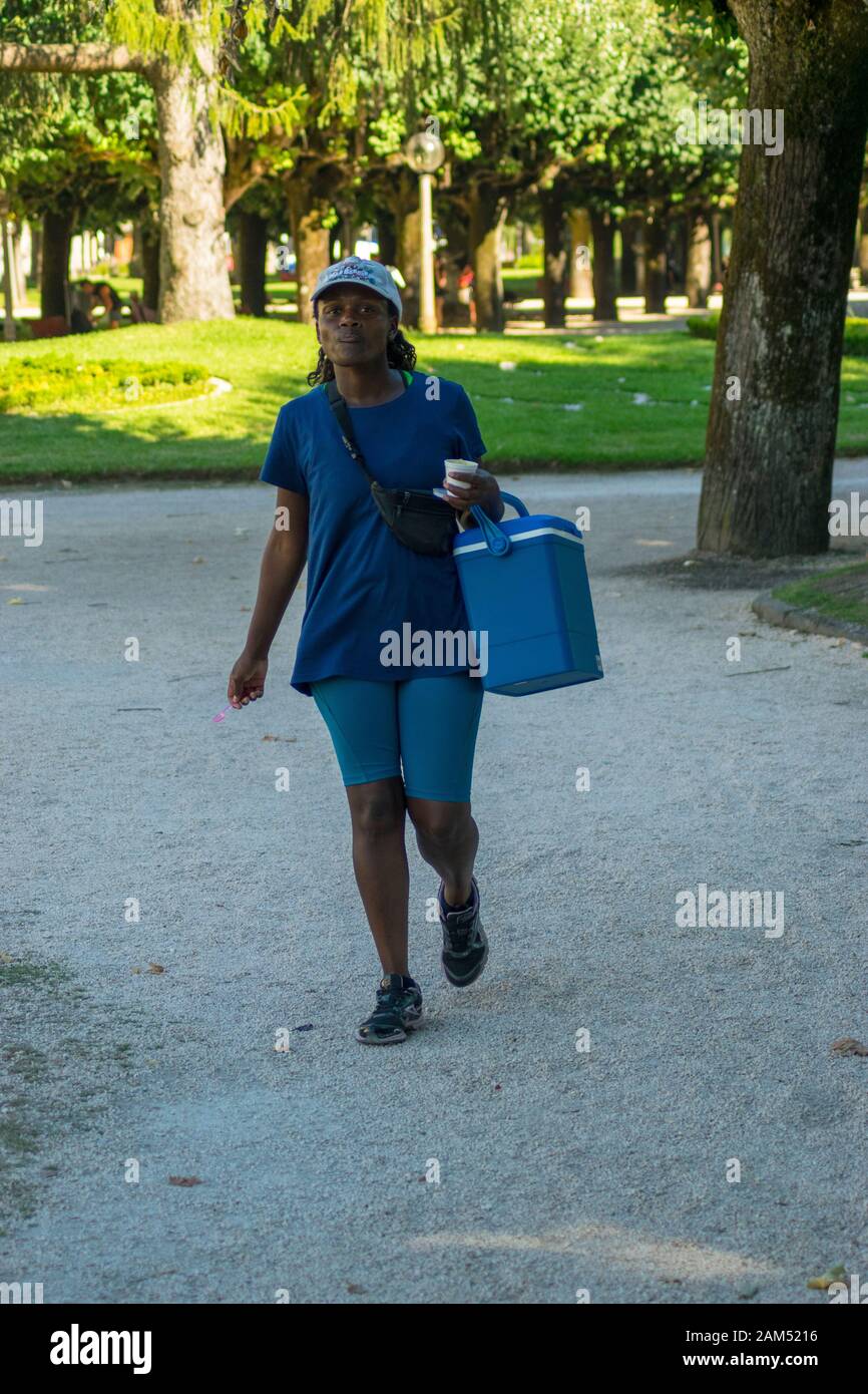 COIMBRA, PORTUGAL - 16 Jul 2016 - A woman selling cold drinks during a heatwave in Coimbra Portugal Stock Photo