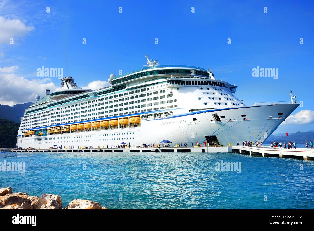 The Royal Caribbean Cruise liner, Explorer of the Seas, moored at at port in Labadee, Haiti. Passengers are disembarking and heading along the jetty Stock Photo