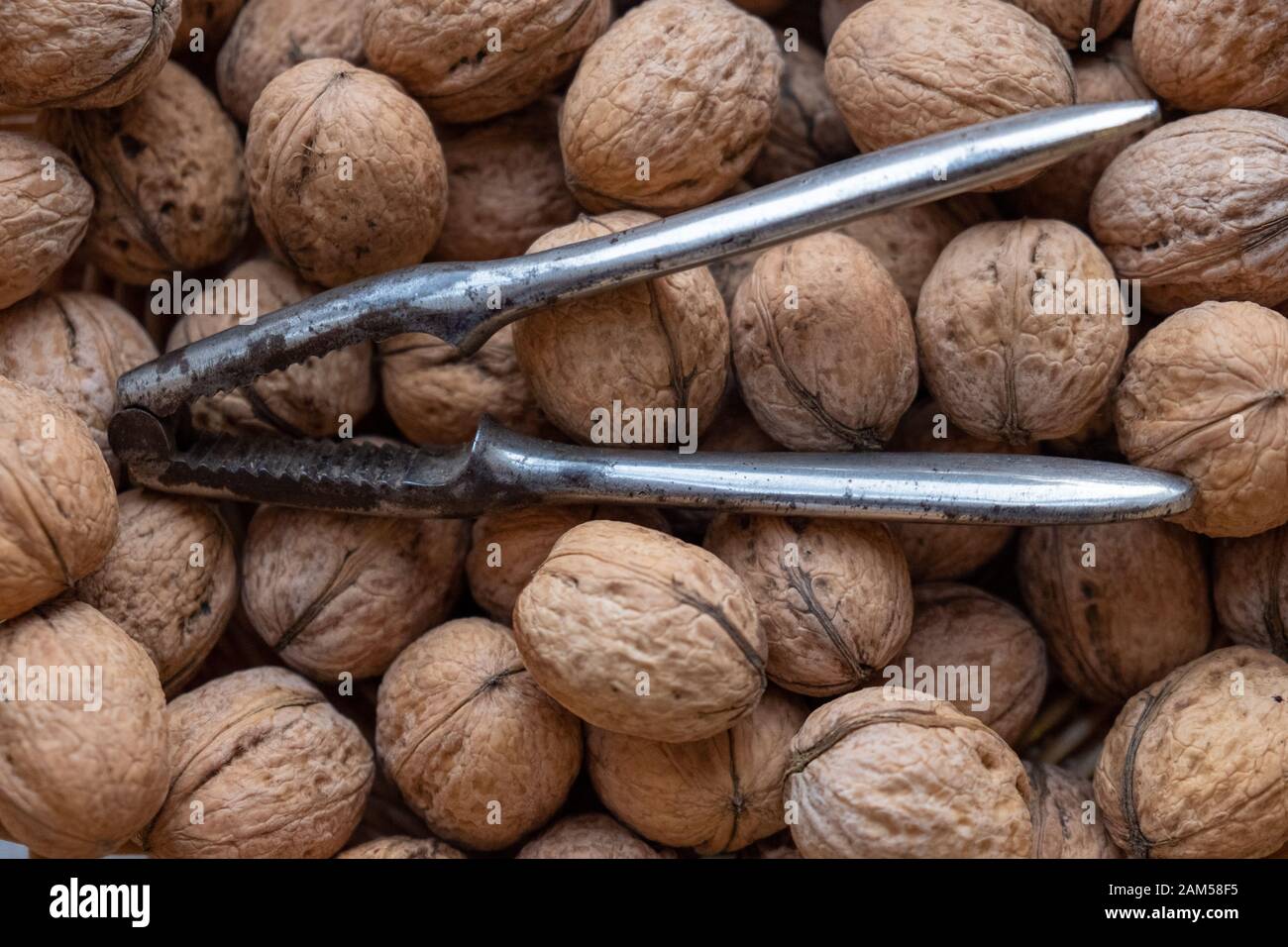 Many walnuts with a nutcracker Stock Photo Alamy