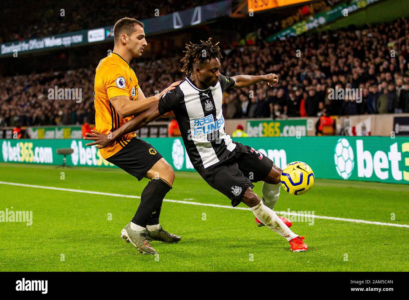 Wolverhampton Uk 11th Jan Christian Atsu Of Newcastle United Controlling The Ball Under Pressure From Jonny Of Wolverhampton Wanderers During The Premier League Match Between Wolverhampton Wanderers And Newcastle United At Molineux