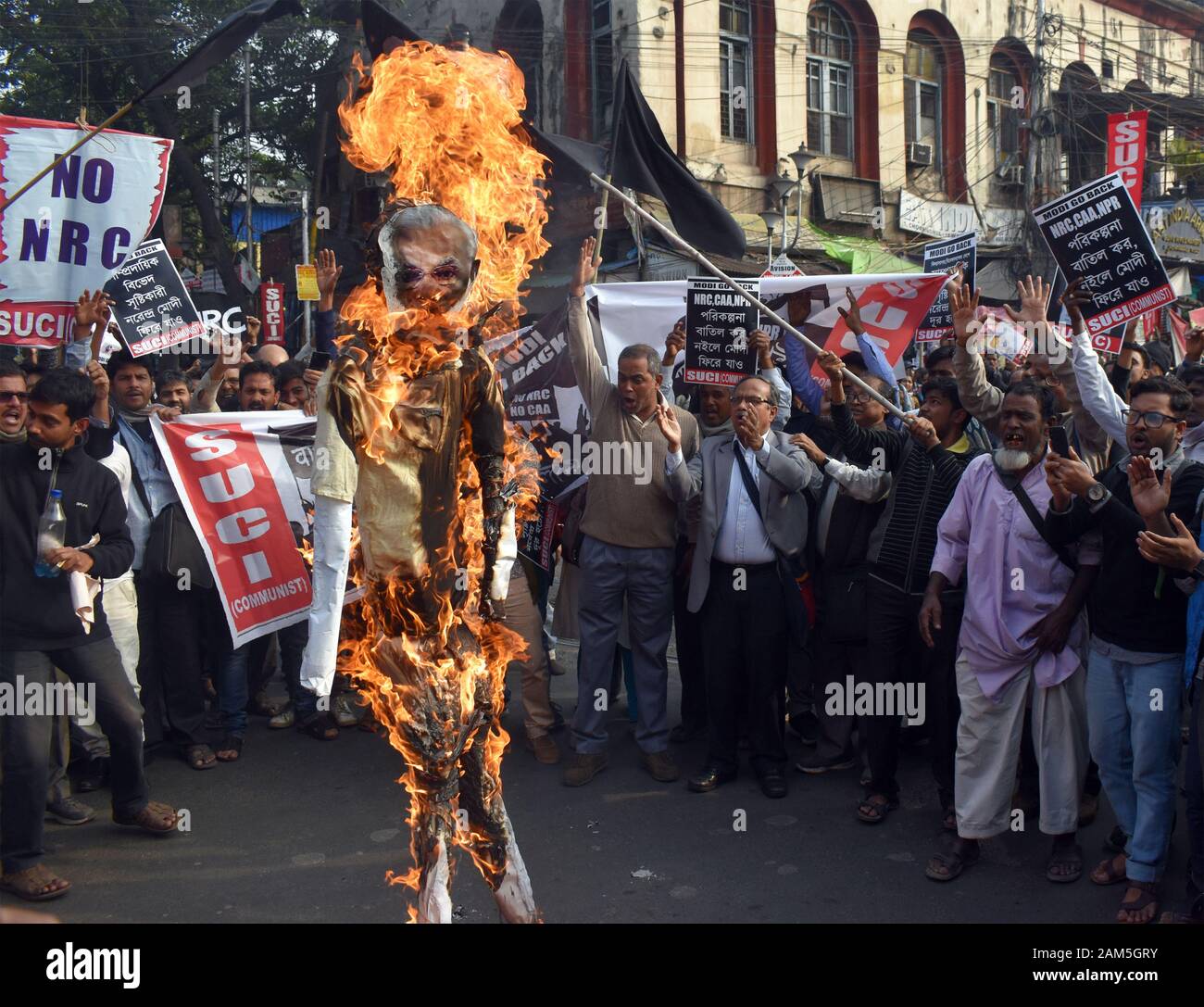 SUCI activists of India shout slogans as they burn an effigy of India's Prime Minister Narendra Modi during a protest rally against the NRC in Kolkata Stock Photo