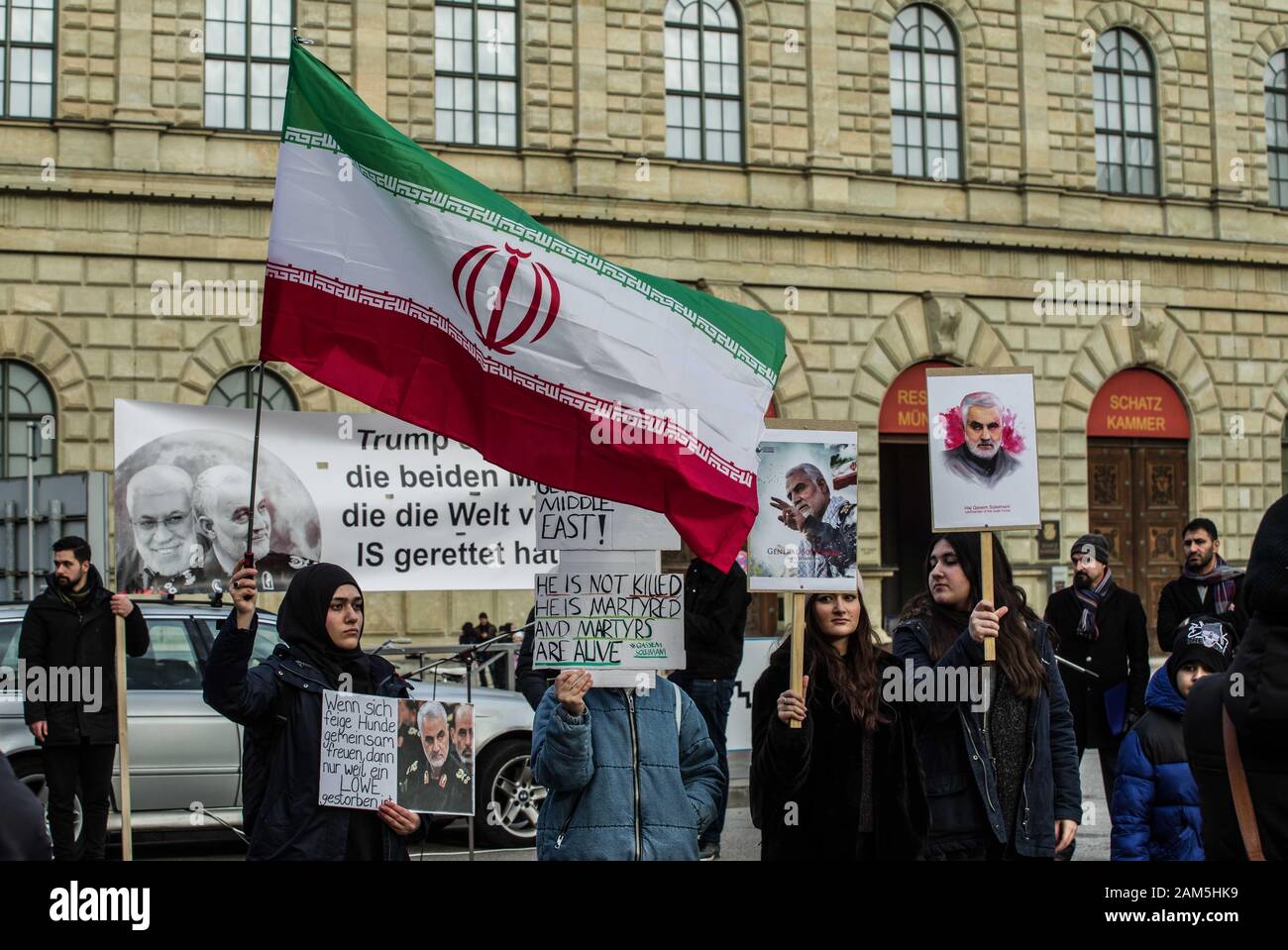 Munich, Bavaria, Germany. 11th Jan, 2020. Demonstrators in Munich, Germany against the Trump-ordered killing of General Qasem Soleimani wave the Iranian flag and demand the exit of US troops from the middle east. Approximately 70 participants from the Iranian community of Munich, Germany demonstrated against the Trump-ordered missile strike in Iraq that resulted in the death of Iranian general Qasem Soleimani and Mahdi al Muhandis.While the group assigned blame to the United States for the killing, large portions of the speeches were directed against Israel and allies of the United States. Cre Stock Photo