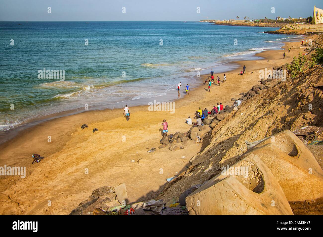 Dakar, Senegal- April 24 2019: Men playing football on the beach near Dakar city in Africa. It is the capital city of Senegal. Stock Photo
