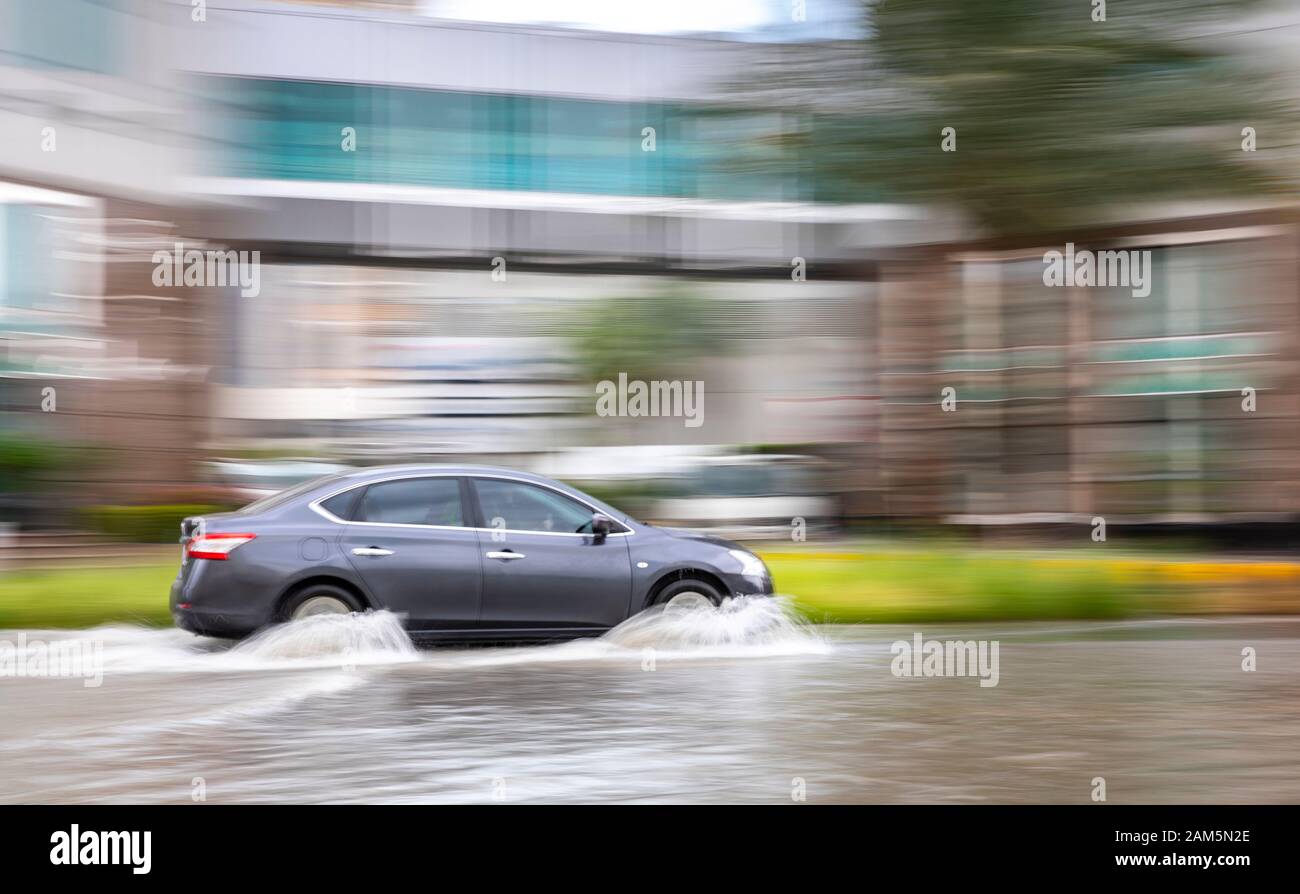 Dubai, United Arab Emirates, 11 January 2020: car driving in flooded street of Dubai after a heavy rainfall Stock Photo