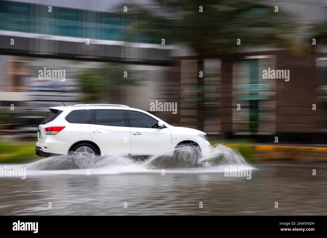 Dubai, United Arab Emirates, 11 January 2020: car driving in flooded street of Dubai after a heavy rainfall Stock Photo