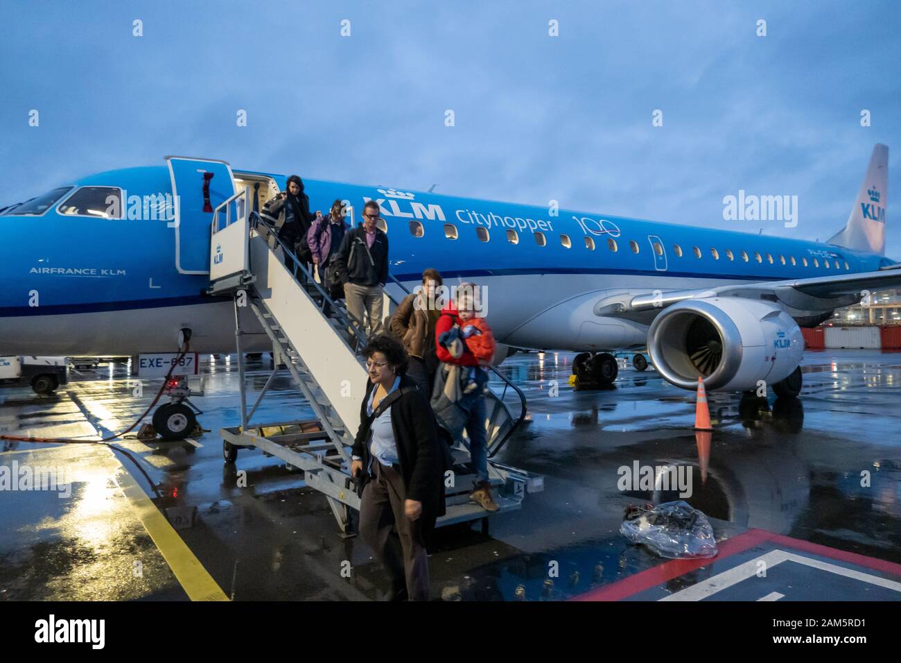 Passengers disembark from KLM Cityhopper flight at Amsterdam Airport Stock Photo
