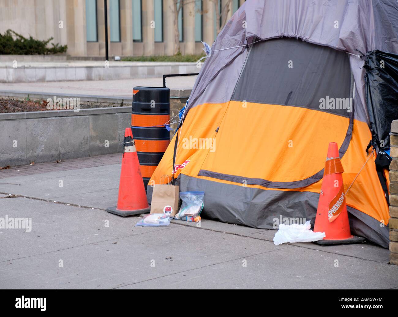 food donations at door of Homeless tent set up on sidewalk on University avenue in the centre of Toronto on a cold, grey, winter day. Stock Photo