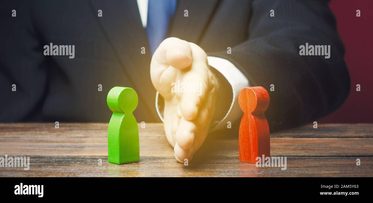 Man divides warring parties conflict with a hand. Mediator services. Stop fight, ceasefire clashes. Finding a compromise. De-escalation of conflict. A Stock Photo