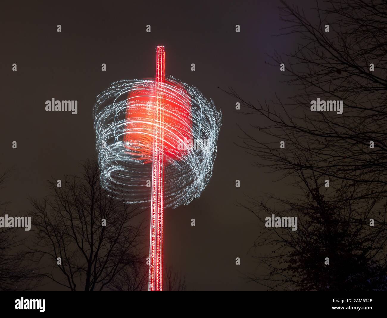 Moving round wheel at night generating abstract lights around the shaft in winter wonderland outdoors, in holiday time, London Stock Photo
