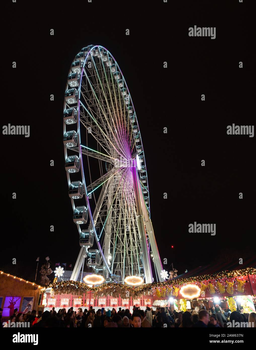 London, England, UK - December 28, 2019: Spinning Ferris wheel at night in winter wonderland in London, in Christmas holiday Stock Photo
